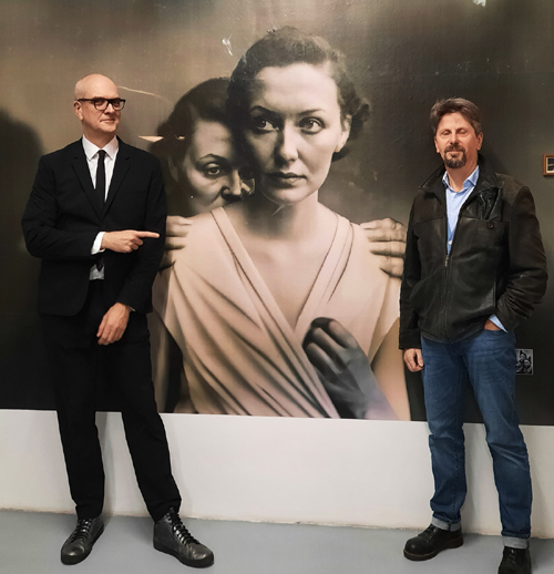 Boris Eldagsen (left, obviously) and Gerald Bauer (right, eyes wide shut). Prominently in the center is a large print of Eldagsen's iconic work The Electrician. The one from the Sony Award? Yeah, that one.